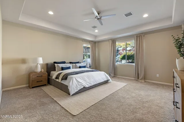 a spacious bedroom with a bed and window