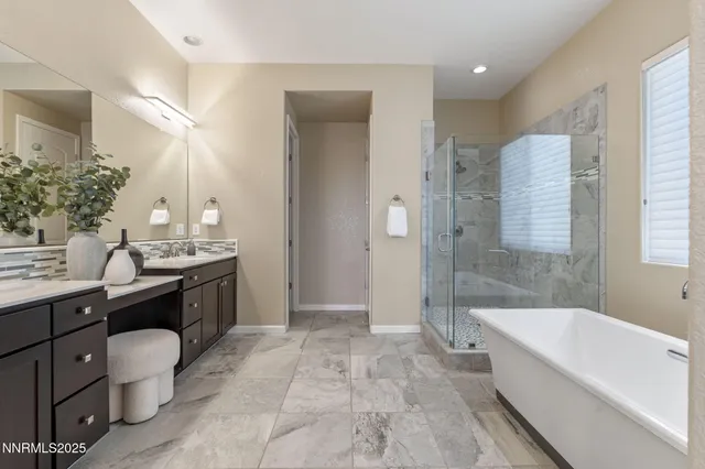 a spacious bathroom with a bathtub sink and mirror