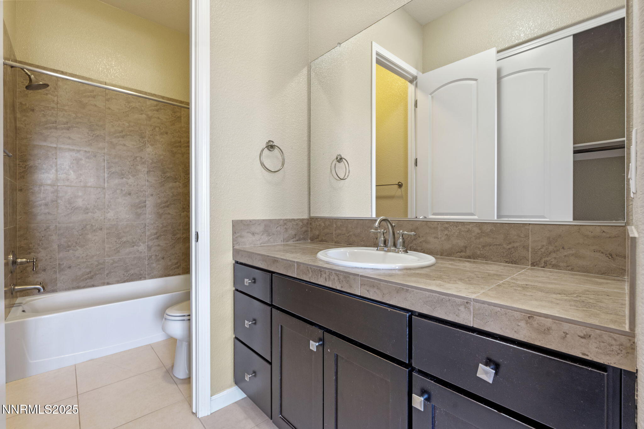 1755 Back Nine Trail Reno, NV 89523 - Photo 33 of 49 a bathroom with a granite countertop sink and a mirror