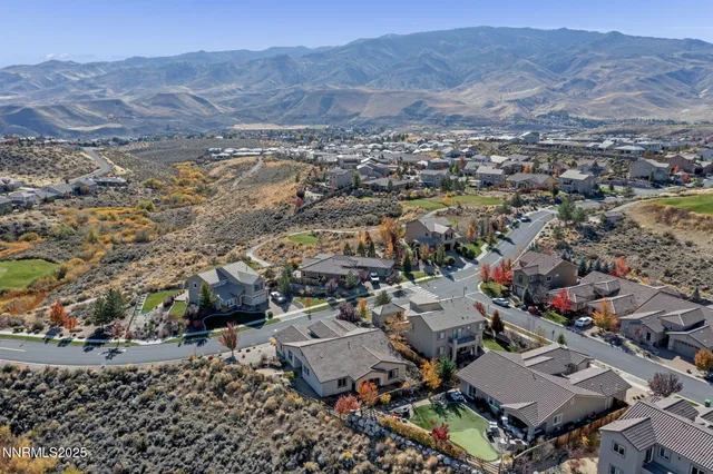 an aerial view of residential house and sandy dunes