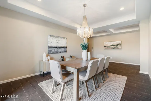 a view of a dining room with furniture a chandelier and wooden floor