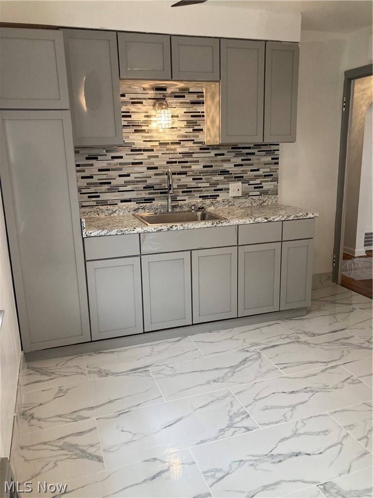 3800 Strandhill Road Cleveland, OH 44128 - Photo 2 of 34 Kitchen featuring gray cabinets, sink, and light countertops