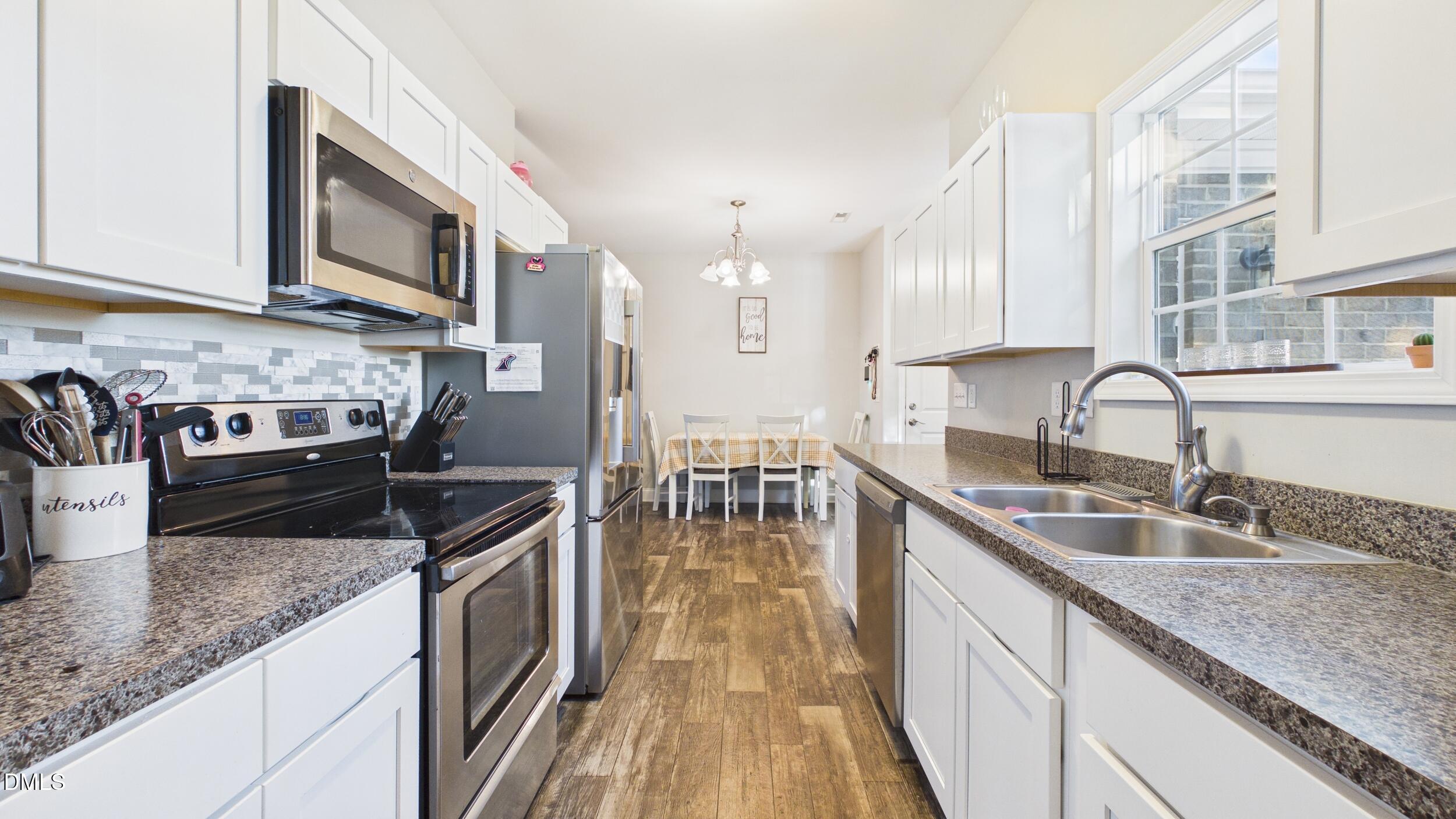5930 Old 421 Road Liberty, NC 27298 - Photo 14 of 42 a kitchen with stainless steel appliances granite countertop a sink stove and microwave