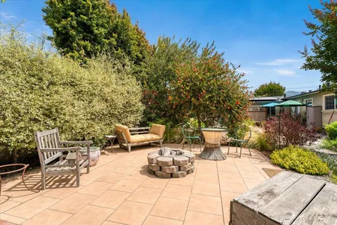a view of a backyard with sitting area