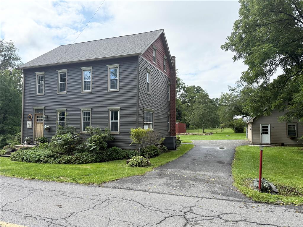 740 Engler Road Nazareth, PA 18064 - Photo 2 of 27 A classic gray-sided residence with neatly kept landscaping, presenting a private retreat from the road.
