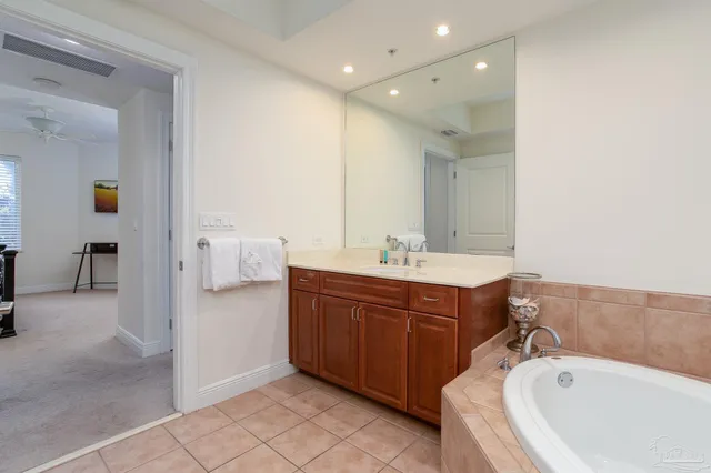 a bedroom with a large bed and a view of bathroom