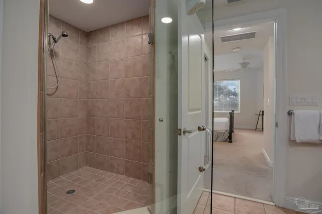 a bedroom with a bed and a large mirror