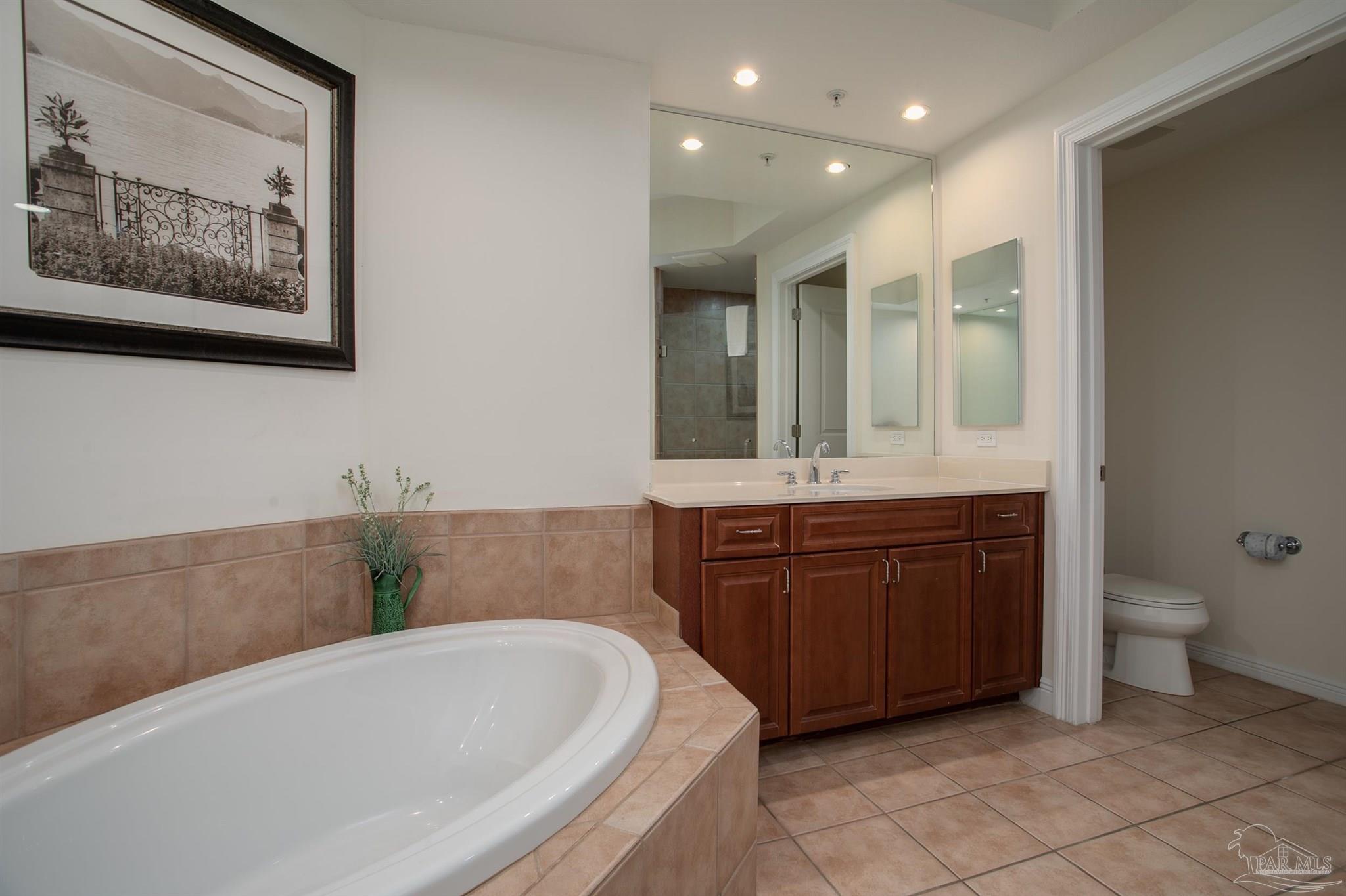 645 Lost Key Drive, Unit 206D Perdido Key, FL 32507 - Photo 24 of 72 a bathroom with a tub sink and mirror