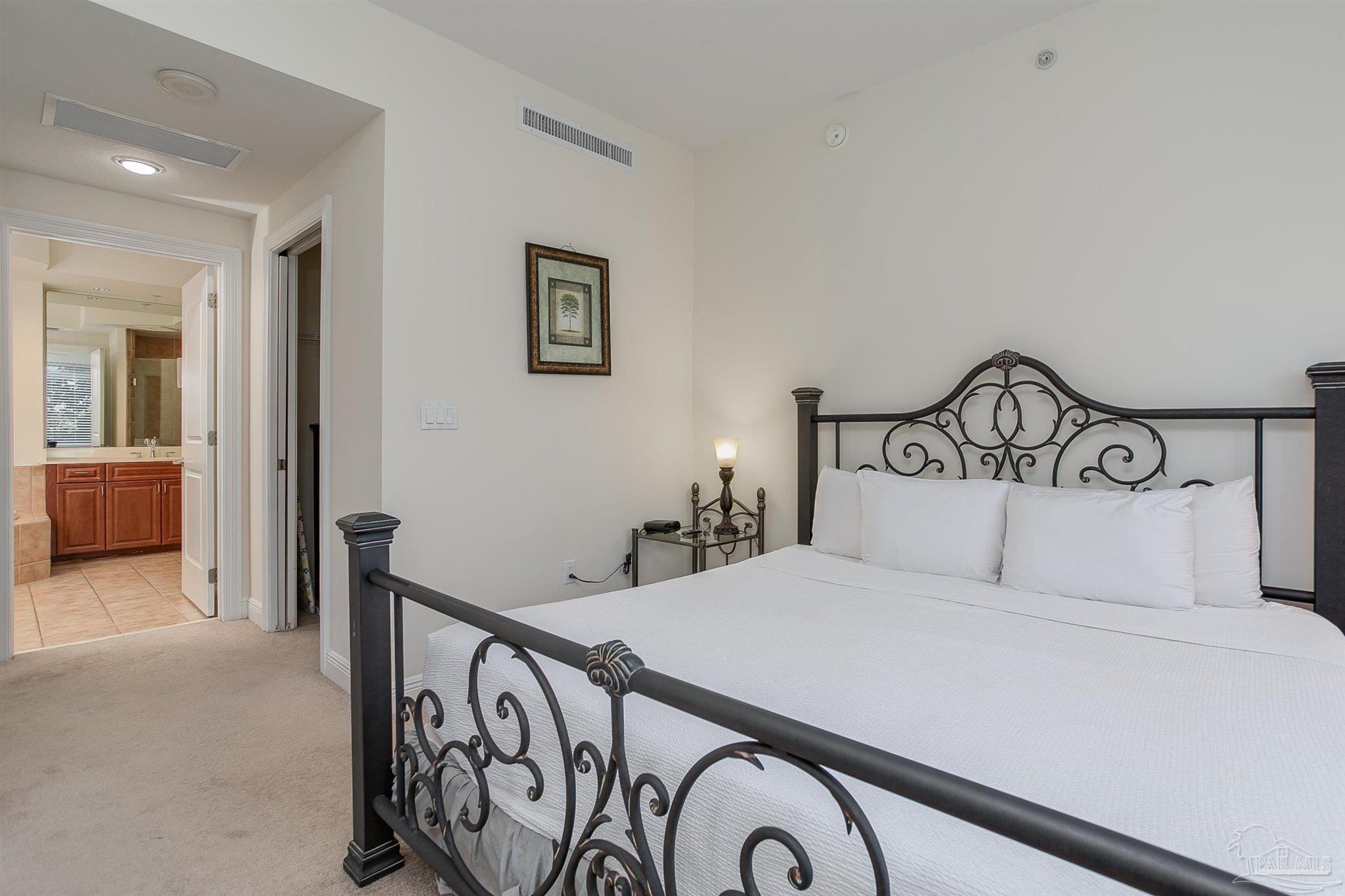 645 Lost Key Drive, Unit 206D Perdido Key, FL 32507 - Photo 31 of 72 a bedroom with a large bed and a view of bathroom