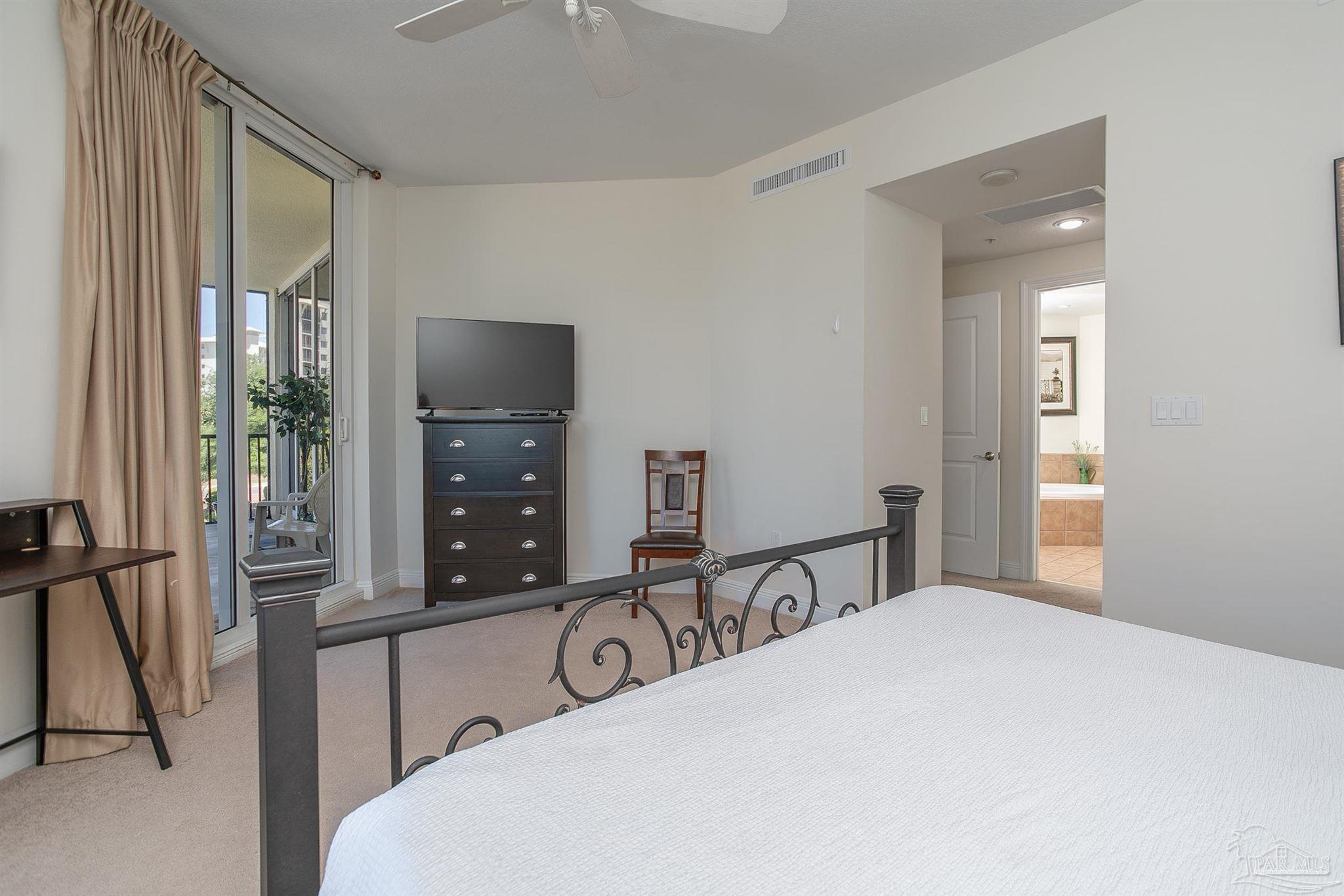 645 Lost Key Drive, Unit 206D Perdido Key, FL 32507 - Photo 32 of 72 a bedroom with a bed and a large mirror