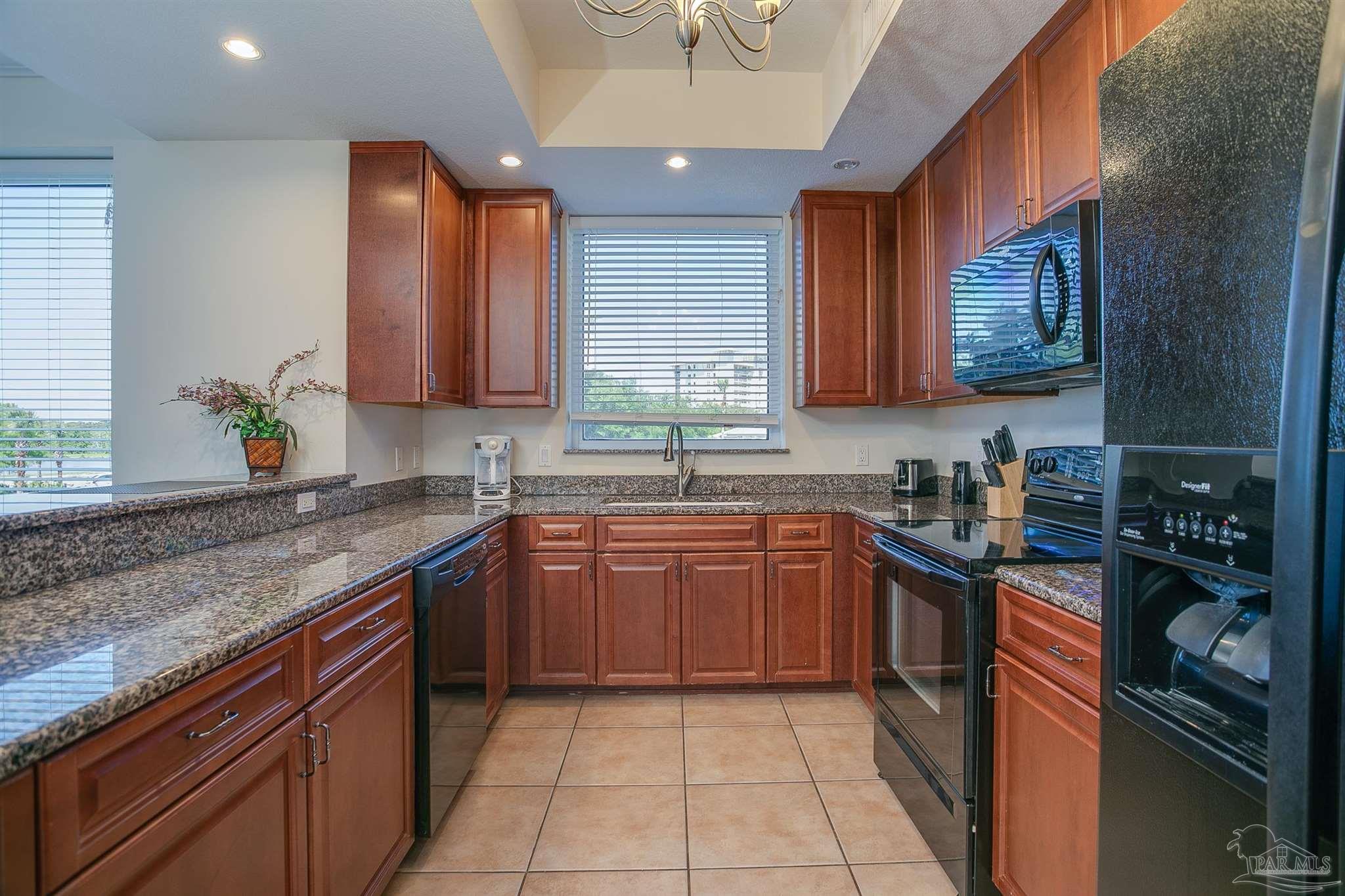 645 Lost Key Drive, Unit 206D Perdido Key, FL 32507 - Photo 33 of 72 a kitchen with stainless steel appliances granite countertop a sink stove and cabinets