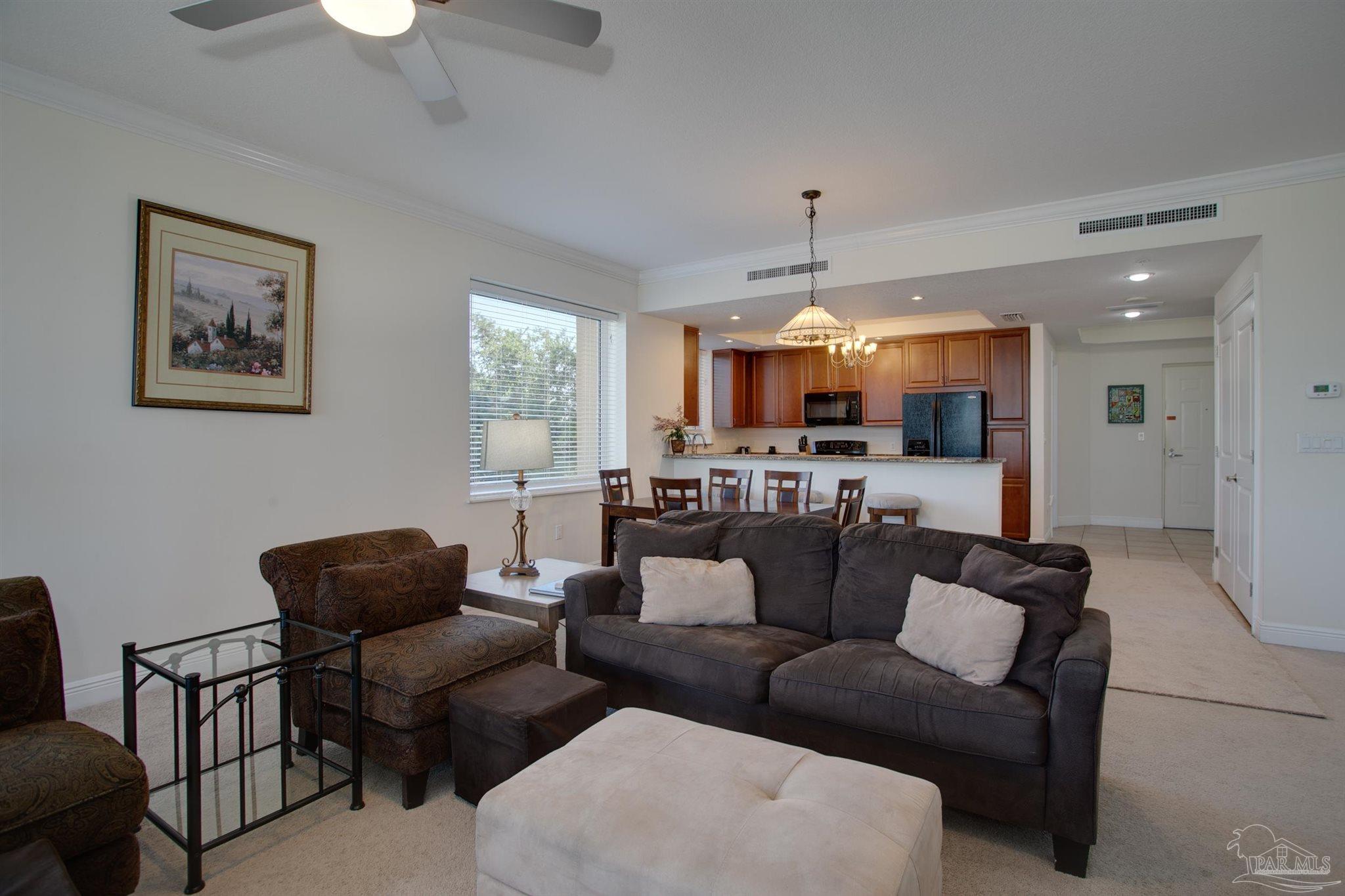645 Lost Key Drive, Unit 206D Perdido Key, FL 32507 - Photo 39 of 60 a living room with furniture kitchen view and a chandelier