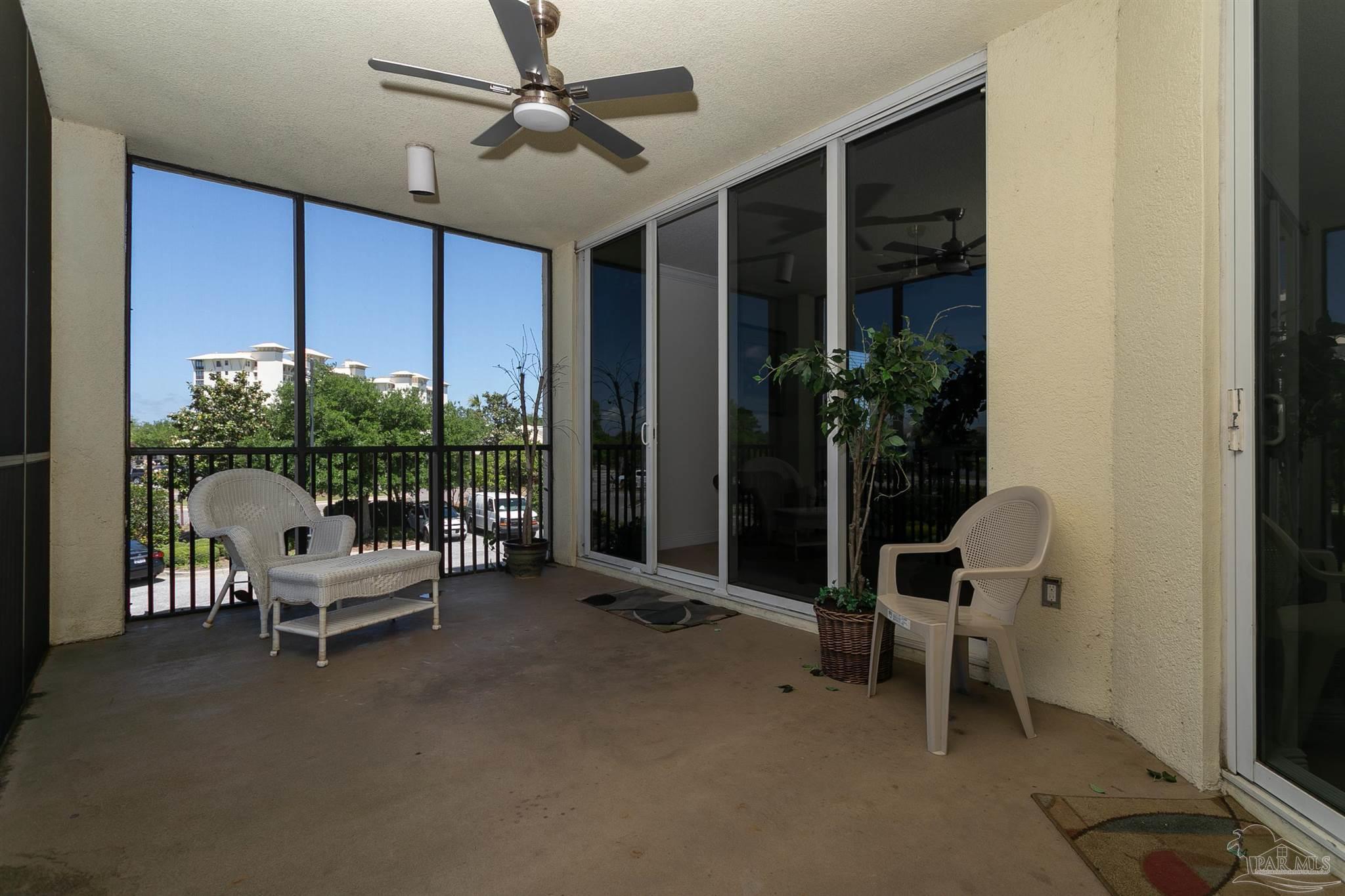 645 Lost Key Drive, Unit 206D Perdido Key, FL 32507 - Photo 48 of 72 a living room with furniture and potted plants next to a chair