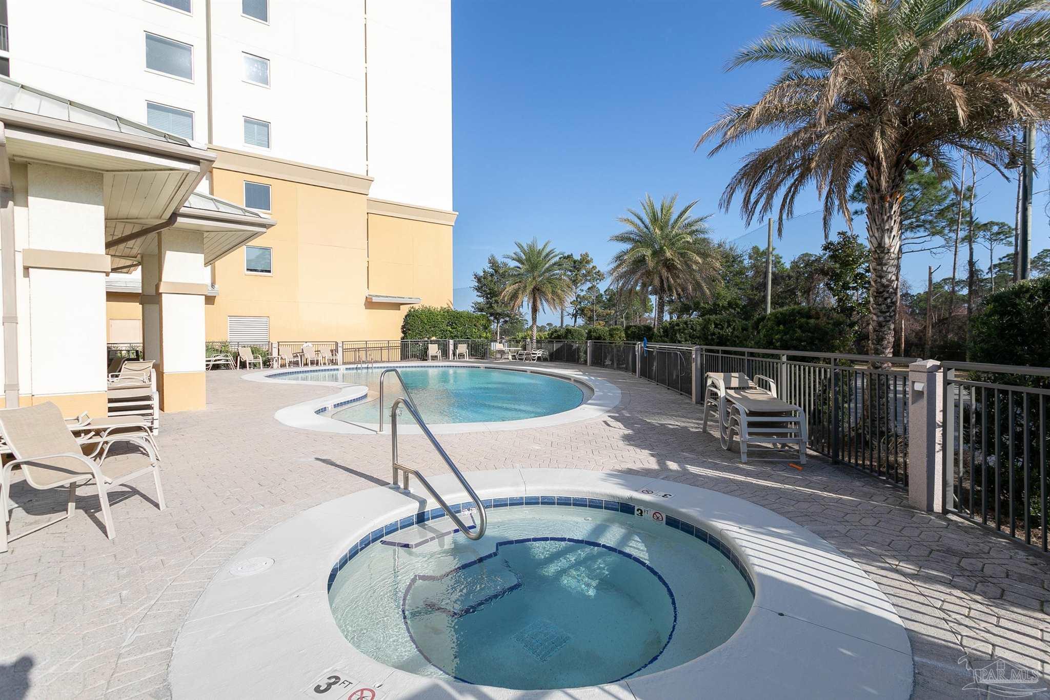645 Lost Key Drive, Unit 206D Perdido Key, FL 32507 - Photo 56 of 72 a view of a swimming pool with a lounge chair