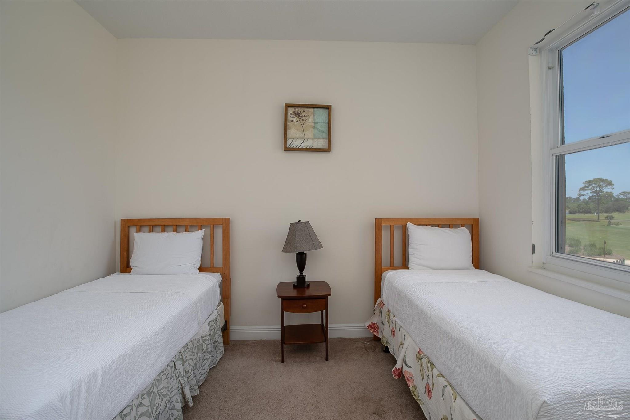 645 Lost Key Drive, Unit 206D Perdido Key, FL 32507 - Photo 9 of 60 a bedroom with a bed and a painting on the wall