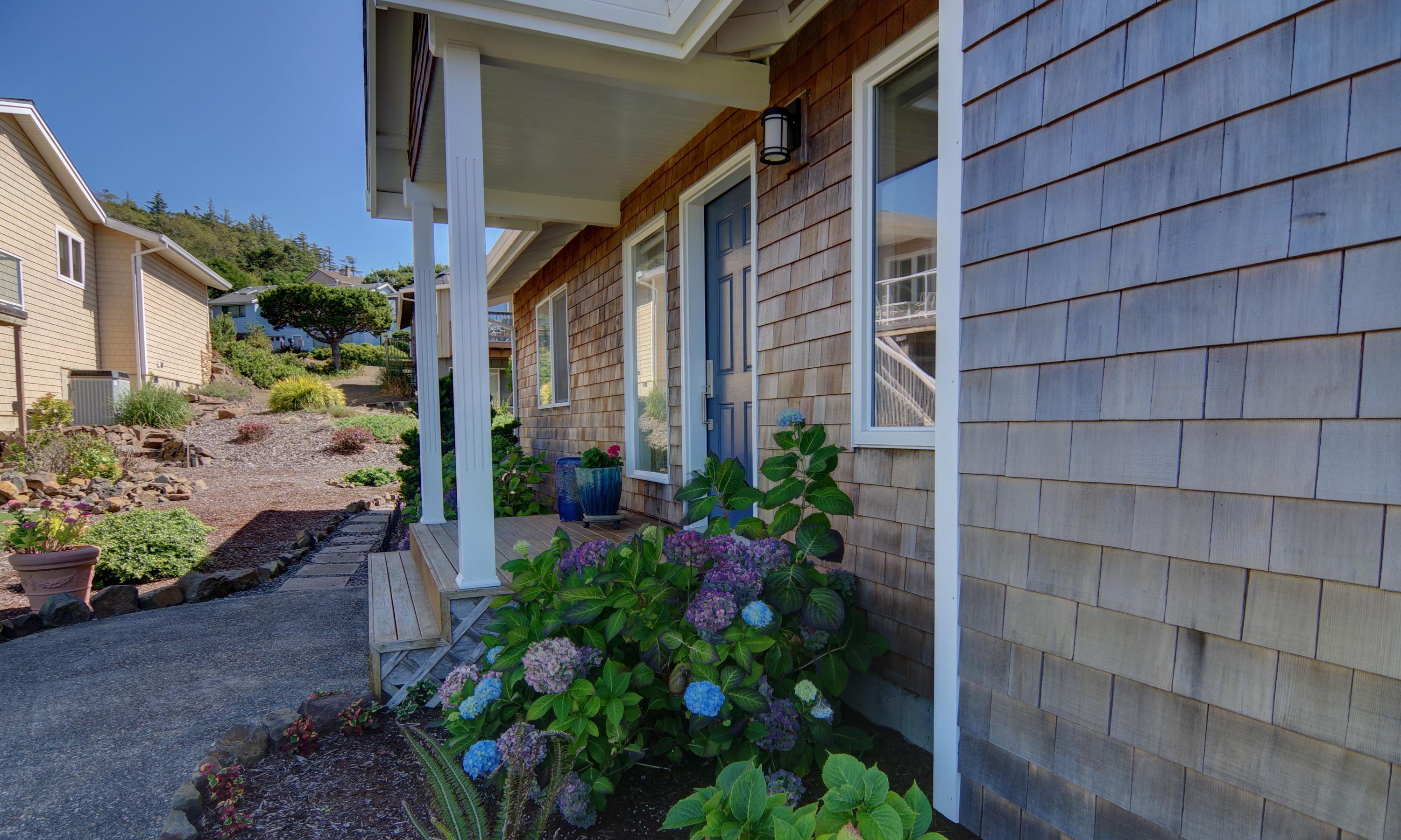 1065 Arthurs Road Oceanside, OR 97141 - Photo 4 of 47 a view of a house with a flower plants