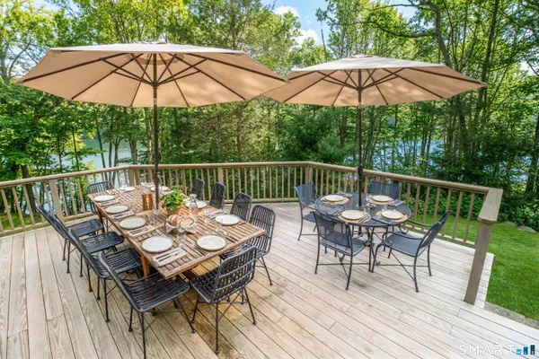 a view of a deck with furniture and wooden deck