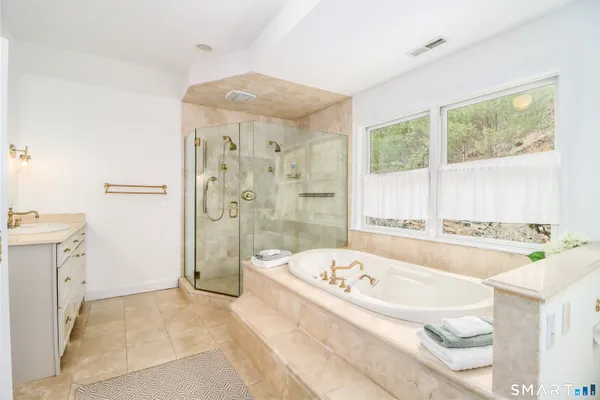 a spacious bathroom with a double vanity sink and a mirror
