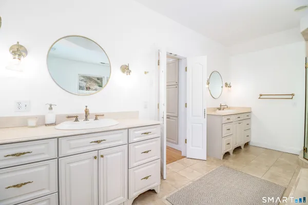 a bedroom with two beds and a chandelier