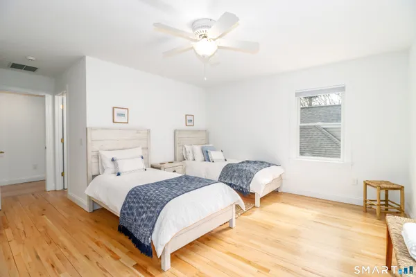 a bedroom with two beds and a window