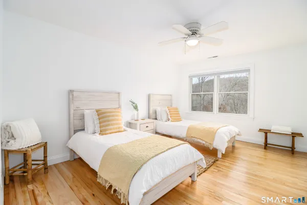 a bedroom with two beds and a lamp