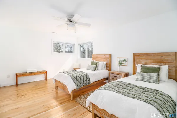 a bedroom with furniture and a large window