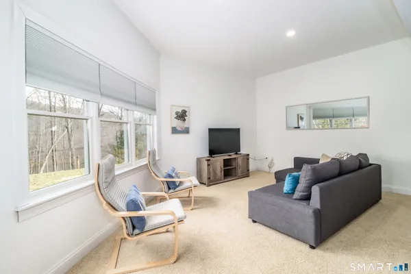 a front view of a house with a garden and trees