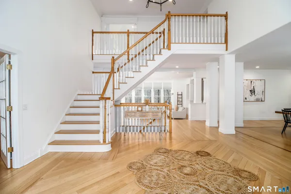 a view of entryway and hall with wooden floor