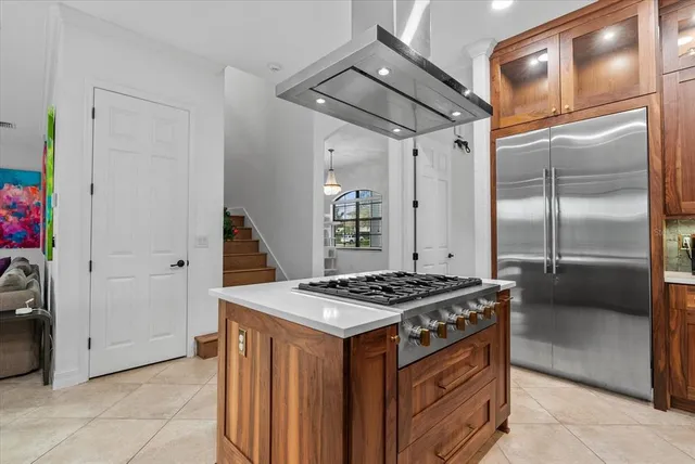 a kitchen with a refrigerator and a stove