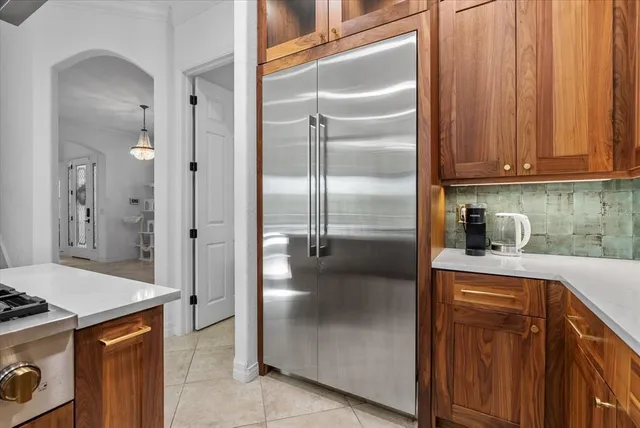 a kitchen with granite countertop wooden cabinets and stainless steel appliances