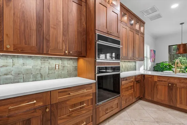 a kitchen with a sink and wooden cabinets