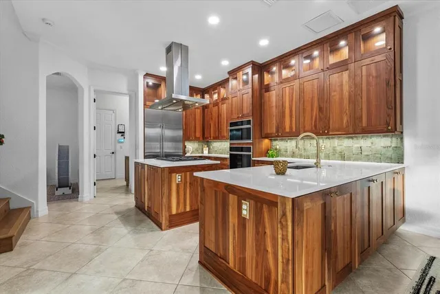 a kitchen with granite countertop cabinets stainless steel appliances and a counter space
