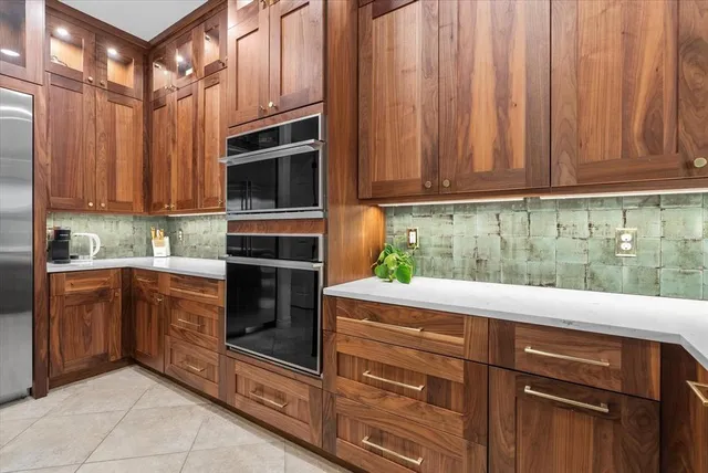 a dining room with furniture a chandelier and wooden floor