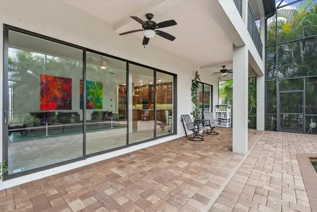 a living room with furniture and a floor to ceiling window