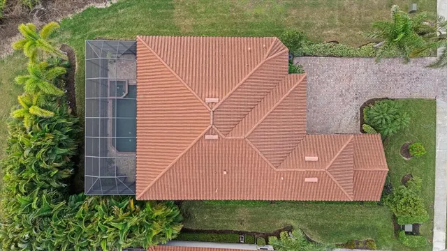 an aerial view of residential houses with outdoor space and river