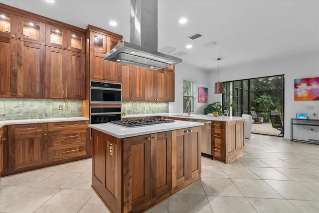 a kitchen with stainless steel appliances granite countertop a stove a refrigerator and a sink