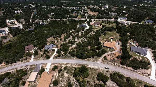 an aerial view of a residential apartment building with a tree