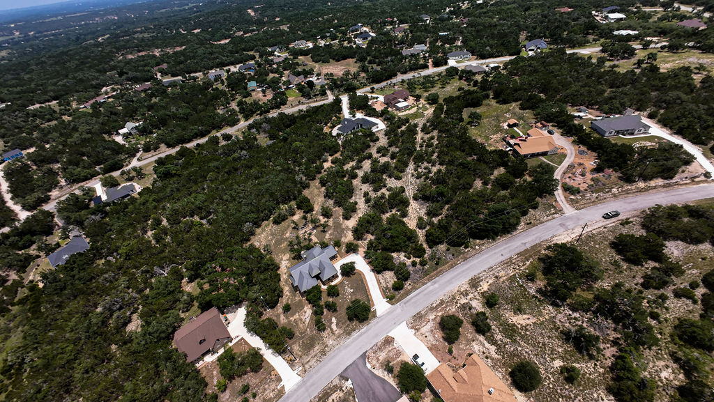 841 Rutherford Fischer, TX 78623 - Photo 22 of 22 an aerial view of a residential apartment building with a tree