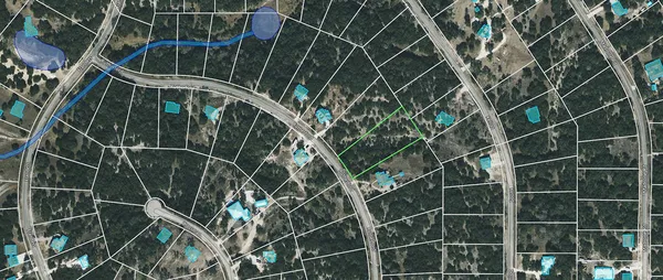 an aerial view of city with green space