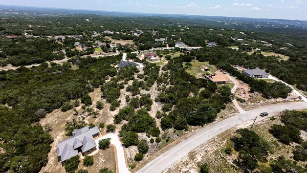 an aerial view of residential houses with city view