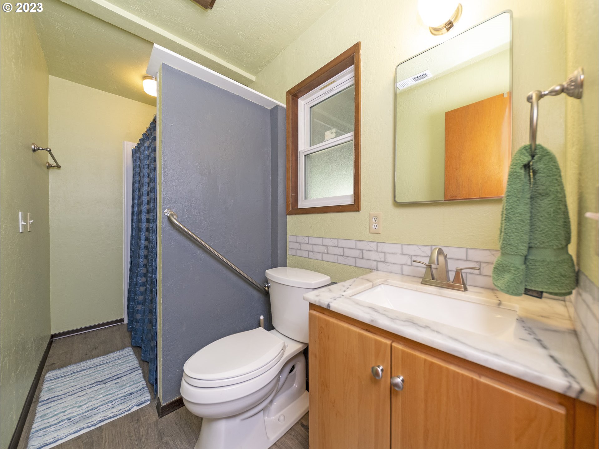 5685 Southwest River Road Hillsboro, OR 97123 - Photo 20 of 46 a bathroom with a granite countertop toilet sink and mirror
