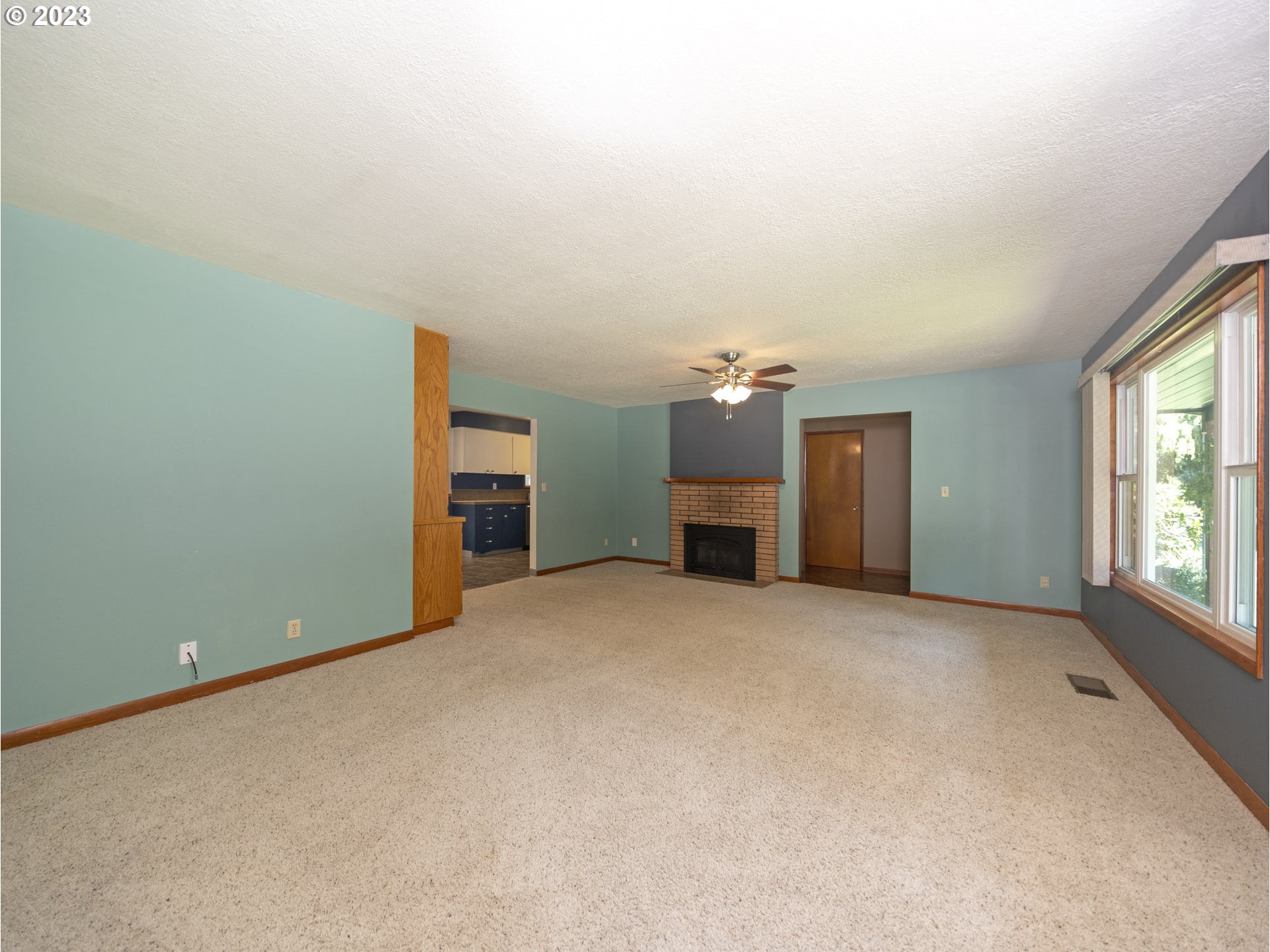 5685 Southwest River Road Hillsboro, OR 97123 - Photo 25 of 46 an empty room with a window and a kitchen
