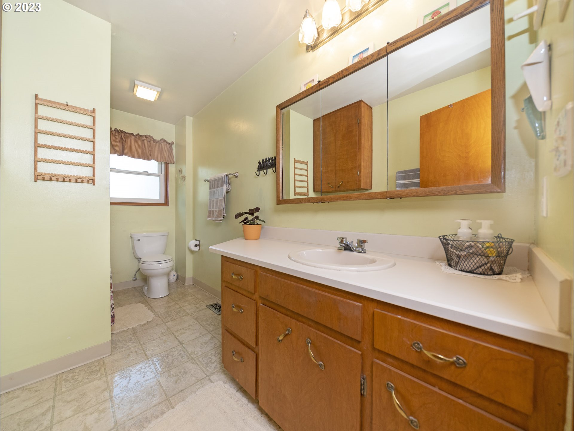 5685 Southwest River Road Hillsboro, OR 97123 - Photo 31 of 46 a en suite bathroom with a granite countertop sink and a mirror