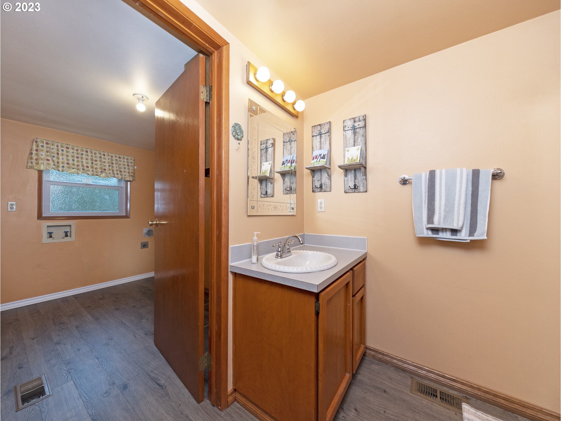 5685 Southwest River Road Hillsboro, OR 97123 - Photo 34 of 46 a bathroom with a sink a mirror and a toilet