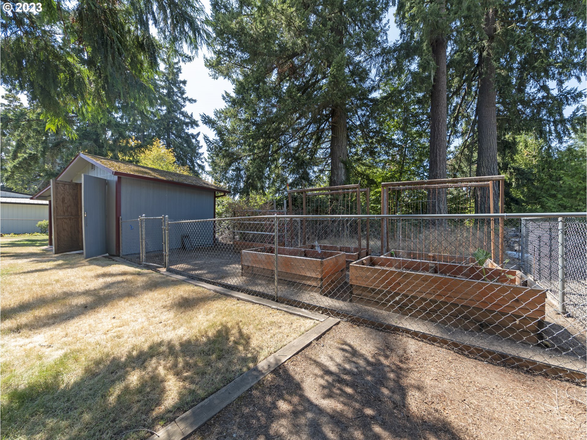 5685 Southwest River Road Hillsboro, OR 97123 - Photo 44 of 46 a view of a backyard with wooden fence and large trees
