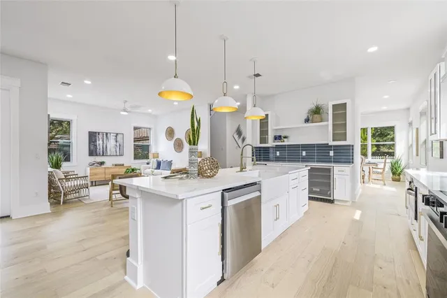 a kitchen with a sink stove and wooden cabinets