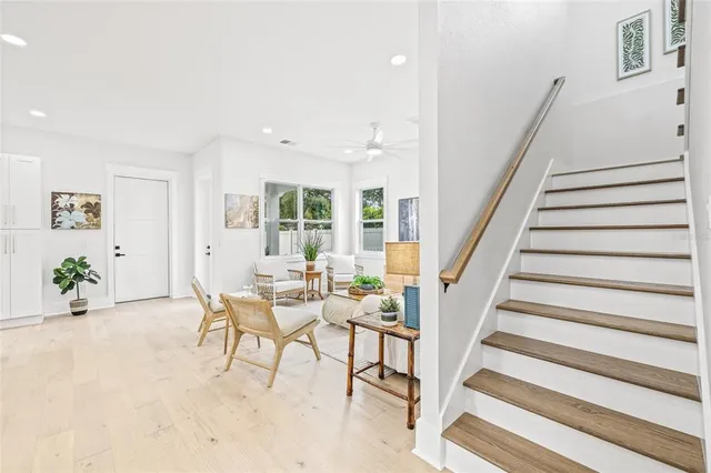 a view of a livingroom with furniture and staircase