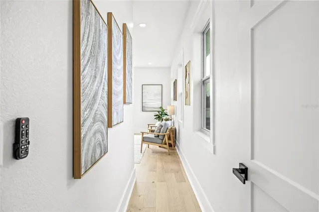 a bedroom with furniture and a large window
