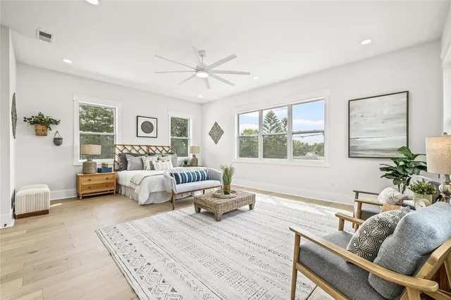 a bedroom with furniture and a large window