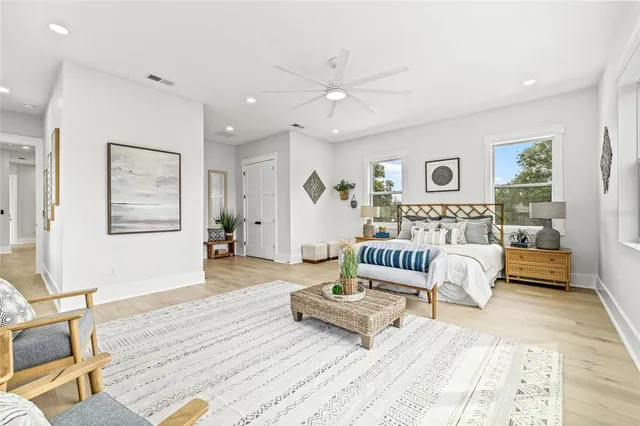 a bedroom with furniture and a large window
